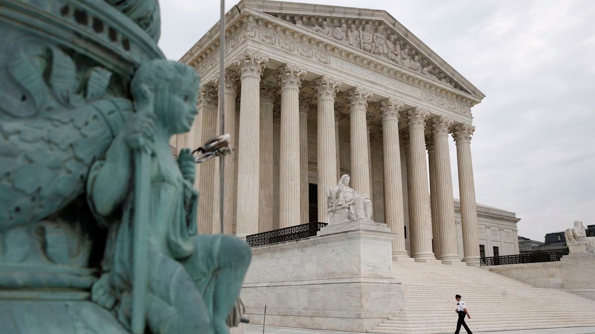 A police officer walks outside the Supreme Court on Capitol Hill in Washington, Monday, July...