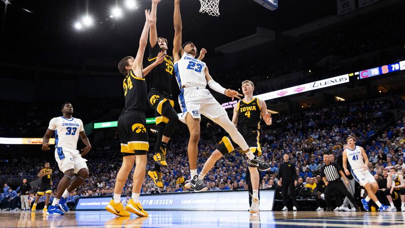 Creighton's Trey Alexander (23) shoots against Iowa's Pryce Sandfort (24), Owen Freeman (32)...