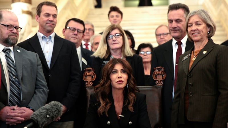 FILE - South Dakota Gov. Kristi Noem signs a bill on Feb. 3, 2022, at the state Capitol in...