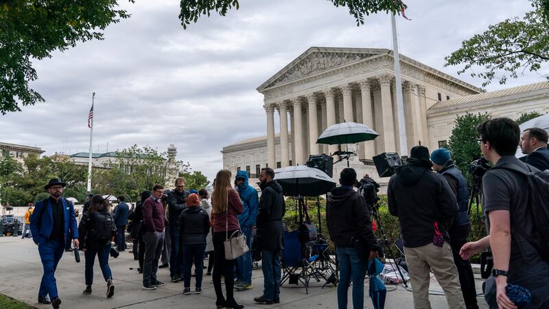 People gather as the Supreme Court begins its new term and to hear the first arguments, on...