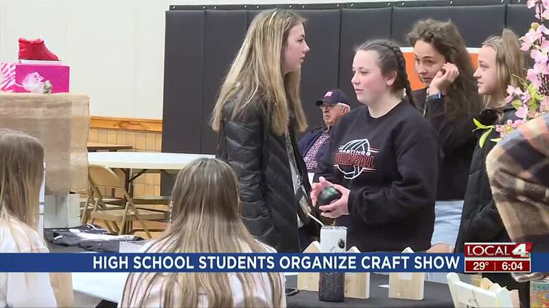 Attendee looks at candles at Hastings Senior High School craft show