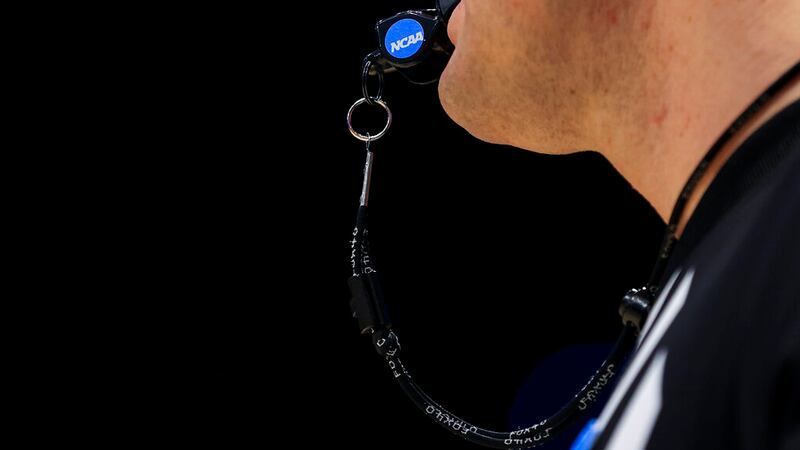 The NCAA logo is seen on the whistle being held by an NCAA official during a First Four game...