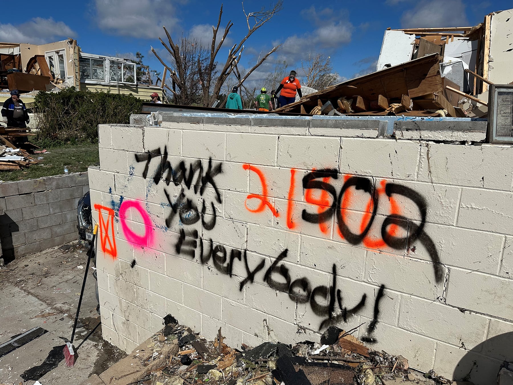 "Thank you everybody" is seend spray painted on a damaged home Monday in Elkhorn. The area was...