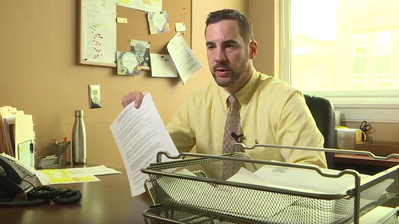 Albert Varas, executive director of the Latino Center for the Midlands, holds up a document...