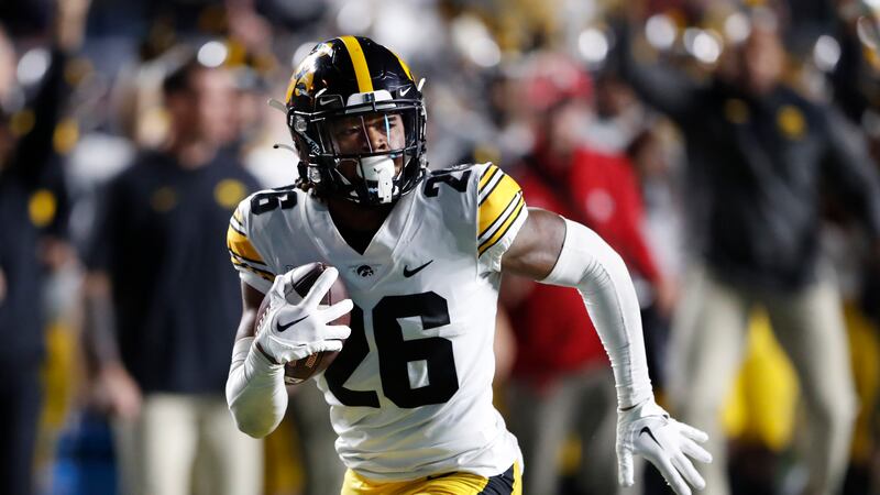 Iowa defensive back Kaevon Merriweather (26) returns a fumble for a touchdown against Rutgers...