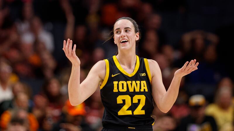 Iowa guard Caitlin Clark reacts after being charged with a foul in the first half against the...