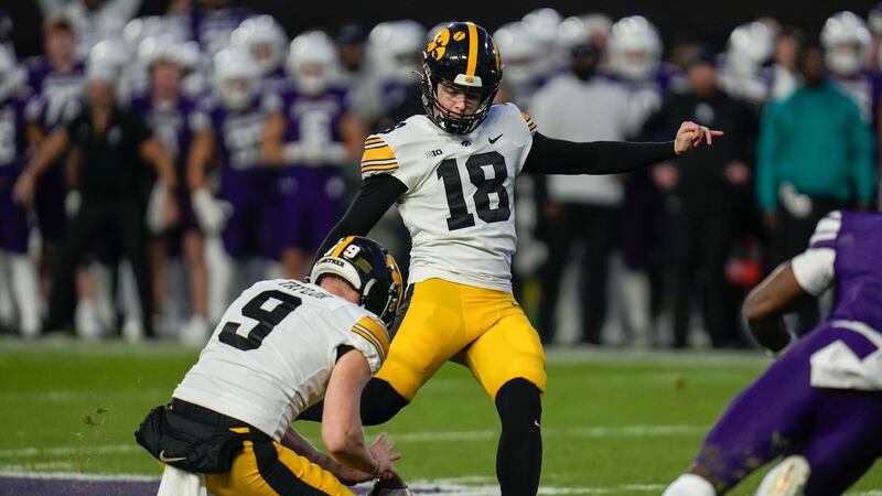 Iowa place-kicker Drew Stevens (18) boots a winning 52-yard field goal during the second half...